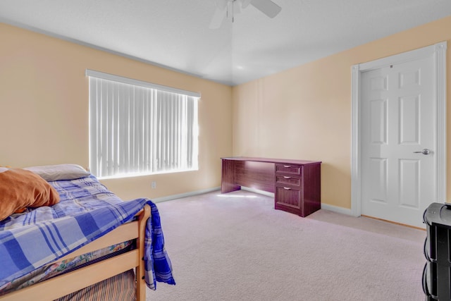 bedroom with ceiling fan, carpet flooring, and baseboards