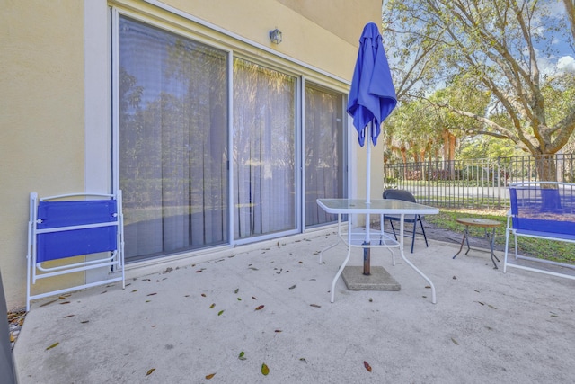 view of patio with fence and outdoor dining space