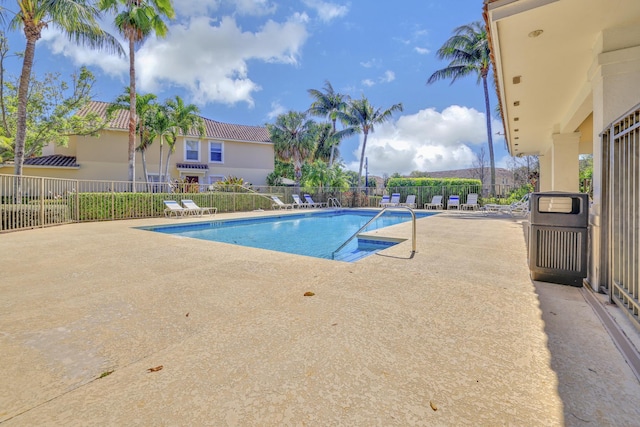 community pool featuring a patio area and fence