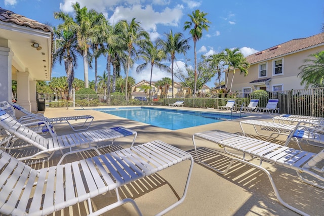 pool featuring a patio area and fence