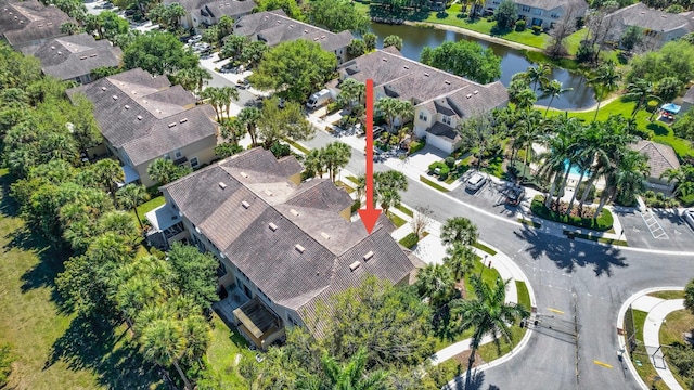 birds eye view of property with a water view and a residential view