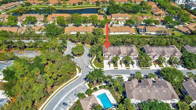 drone / aerial view with a water view and a residential view