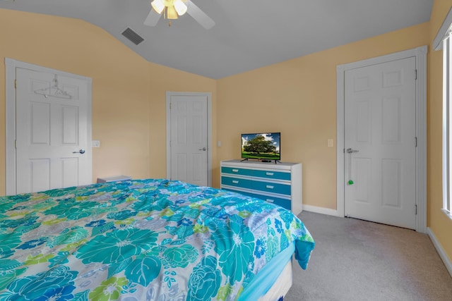 bedroom featuring baseboards, visible vents, a ceiling fan, lofted ceiling, and carpet