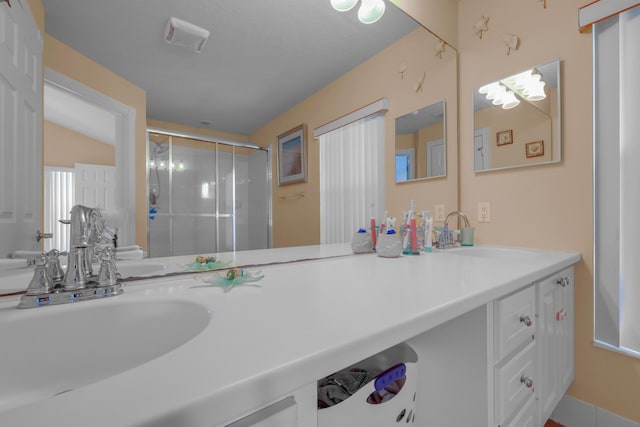 full bathroom with a shower stall and vanity