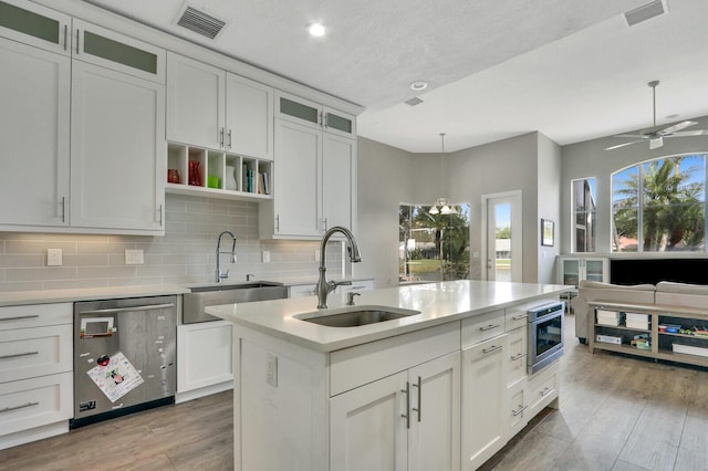 kitchen featuring dishwasher, light countertops, visible vents, and a sink