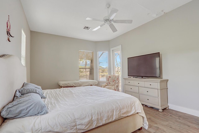 bedroom featuring visible vents, baseboards, a ceiling fan, and light wood finished floors