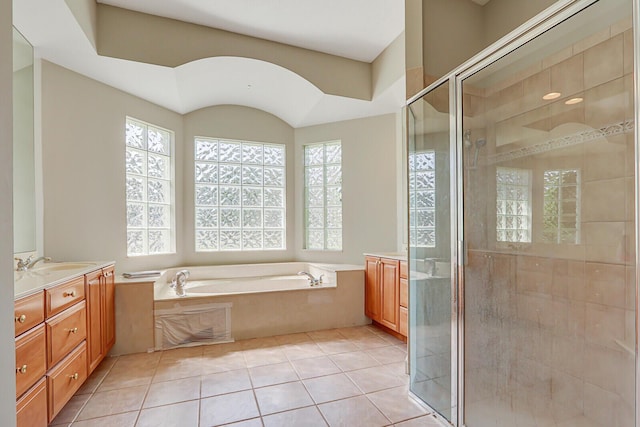 bathroom featuring vanity, a shower stall, a garden tub, and tile patterned flooring