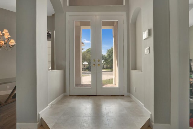 doorway featuring french doors and baseboards