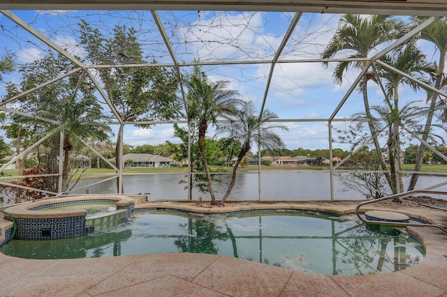 view of pool with glass enclosure, a water view, and a patio