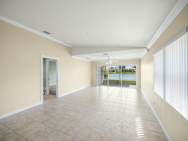 empty room featuring light tile patterned flooring, baseboards, visible vents, and ornamental molding