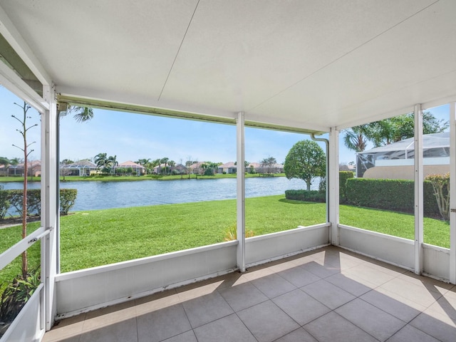 unfurnished sunroom featuring a water view