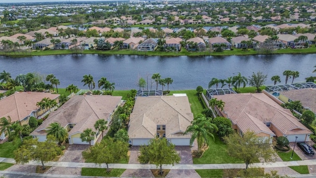 drone / aerial view featuring a residential view and a water view