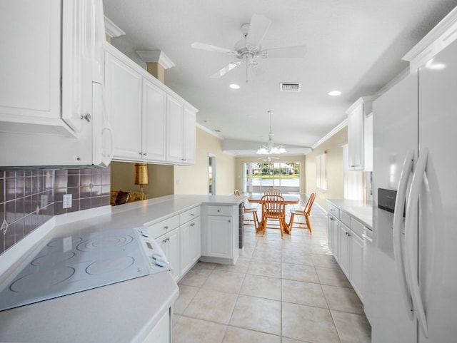 kitchen with white fridge with ice dispenser, ornamental molding, a peninsula, and visible vents