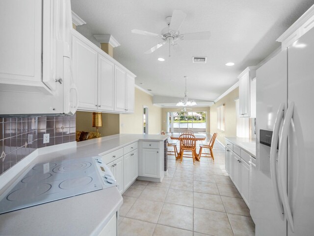 kitchen with white appliances, tasteful backsplash, light tile patterned floors, a peninsula, and crown molding