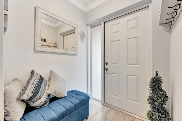 foyer entrance featuring wood finished floors and crown molding