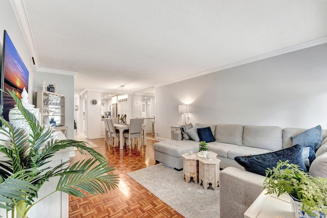 living room with crown molding, a textured ceiling, and baseboards