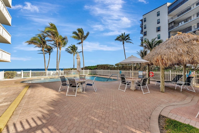 community pool featuring fence and a patio