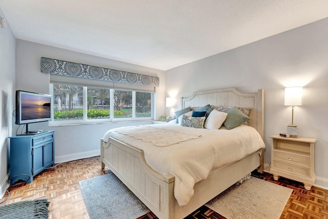 bedroom featuring a textured ceiling and baseboards