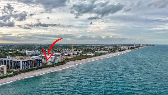 aerial view featuring a water view, a view of the beach, and a city view