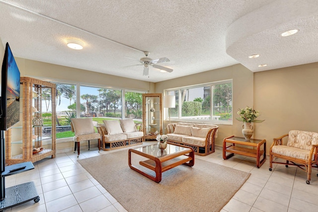 tiled living room with a healthy amount of sunlight and ceiling fan