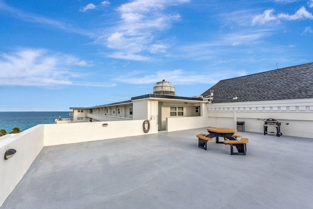 view of patio / terrace with a water view and area for grilling