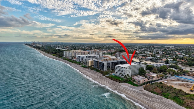 aerial view featuring a water view, a beach view, and a city view