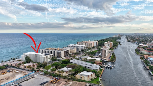 drone / aerial view featuring a water view and a view of city