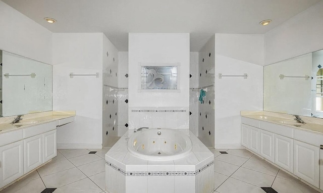 bathroom with tile patterned flooring, a tub with jets, walk in shower, and a sink