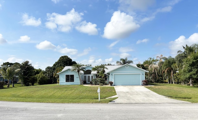 1826 SW Stratford Way, Palm City, FL 34990 - ranch-style house featuring driveway, a front yard, a garage, french doors, and view of wooded area