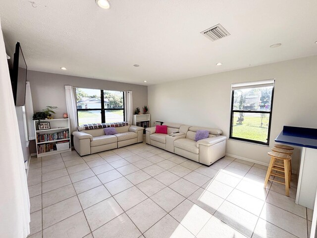 1826 SW Stratford Way, Palm City, FL 34990 - living room featuring recessed lighting, light tile patterned flooring, and baseboards