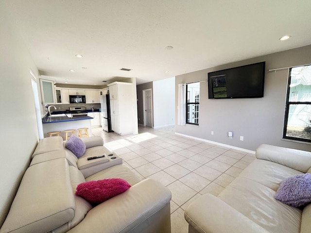 1826 SW Stratford Way, Palm City, FL 34990 - living area featuring light tile patterned floors, recessed lighting, and baseboards