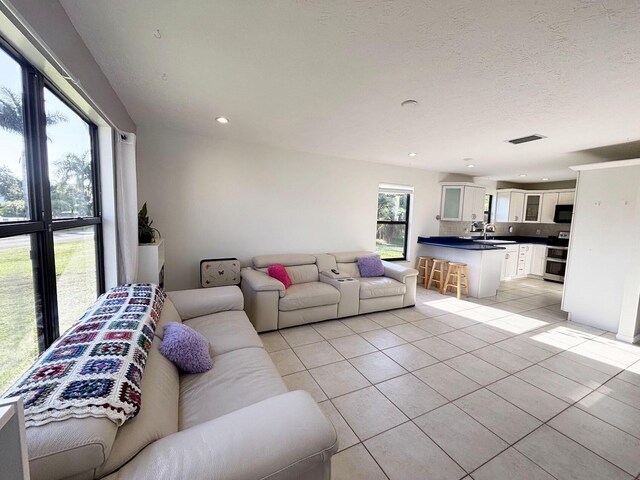 1826 SW Stratford Way, Palm City, FL 34990 - living room featuring light tile patterned flooring and recessed lighting