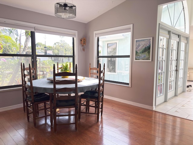 1826 SW Stratford Way, Palm City, FL 34990 - dining area featuring light wood-style floors, baseboards, and vaulted ceiling