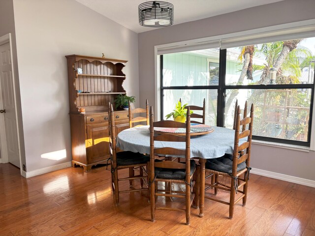 1826 SW Stratford Way, Palm City, FL 34990 - dining room featuring baseboards, light wood-style flooring, and lofted ceiling