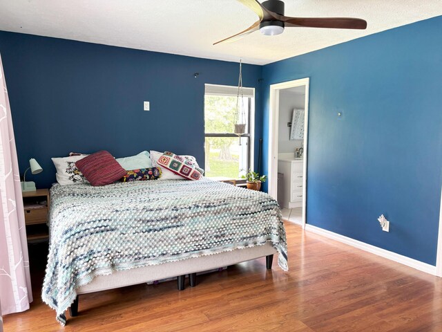 1826 SW Stratford Way, Palm City, FL 34990 - bedroom with wood finished floors, baseboards, ensuite bath, and ceiling fan