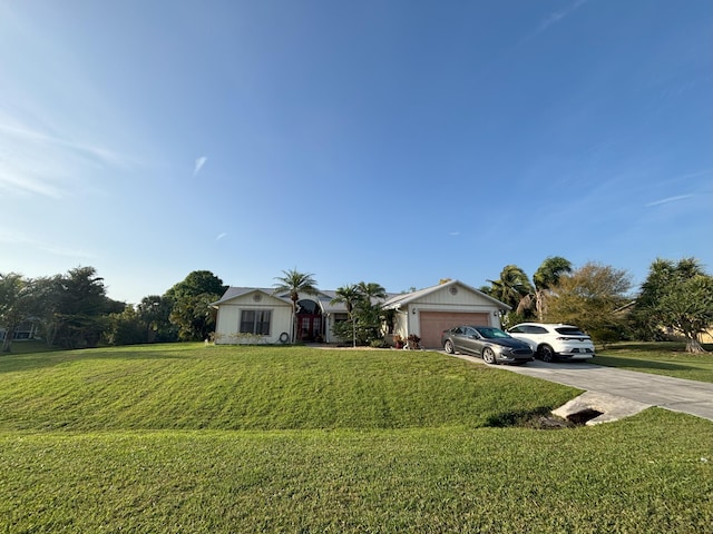 view of front of property featuring a front yard, driveway, and an attached garage