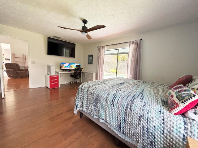 1826 SW Stratford Way, Palm City, FL 34990 - bedroom featuring wood finished floors, access to outside, a textured ceiling, ceiling fan, and a desk