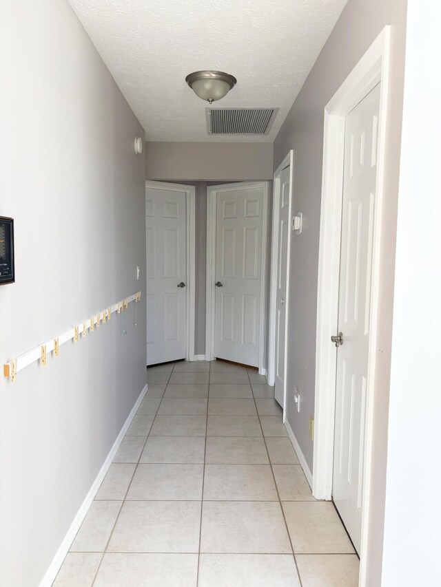 1826 SW Stratford Way, Palm City, FL 34990 - hallway with light tile patterned floors and baseboards