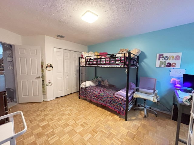 1826 SW Stratford Way, Palm City, FL 34990 - bedroom featuring a textured ceiling and a closet