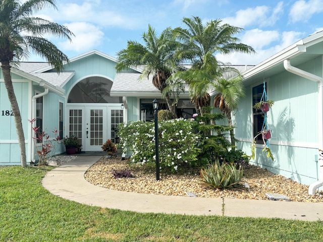 1826 SW Stratford Way, Palm City, FL 34990 - property entrance with a shingled roof and french doors