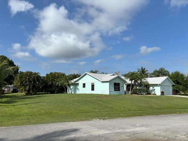1826 SW Stratford Way, Palm City, FL 34990 - view of front of home with an attached garage, a front lawn, and driveway