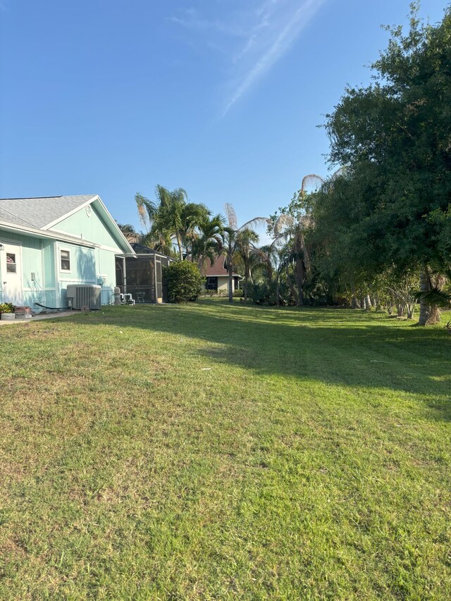 1826 SW Stratford Way, Palm City, FL 34990 - view of grassy yard with cooling unit