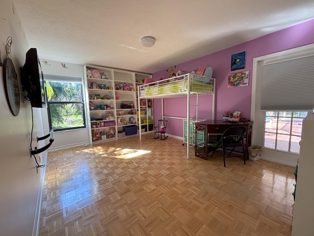 unfurnished bedroom with a textured ceiling and baseboards