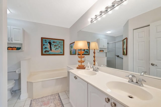 full bathroom with a sink, a garden tub, and tile patterned flooring