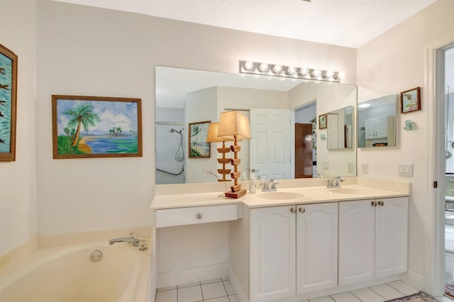 full bathroom featuring tile patterned flooring, double vanity, a bath, and a sink