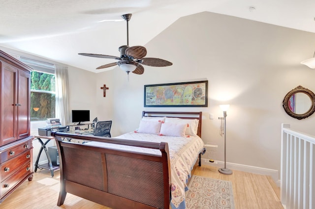 bedroom with light wood finished floors, ceiling fan, baseboards, and lofted ceiling