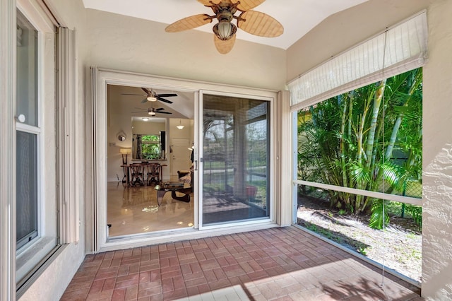 unfurnished sunroom with ceiling fan