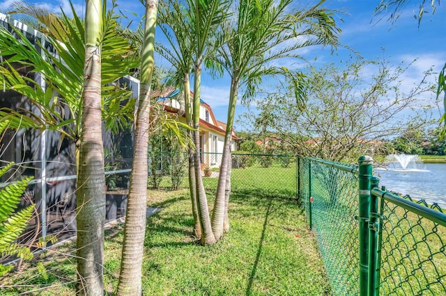 view of yard featuring a gate, a water view, and fence