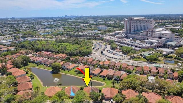 drone / aerial view featuring a residential view and a water view