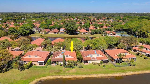 drone / aerial view featuring a residential view and a water view